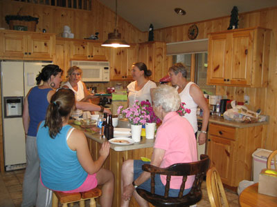 women chatting around a kitchen island