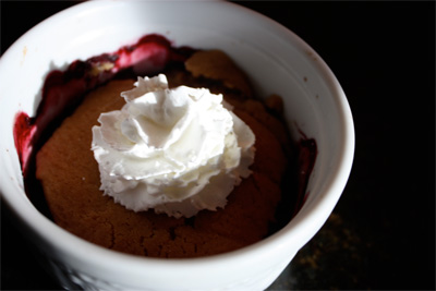 ramekin of berries with whipped cream on top of the cookie