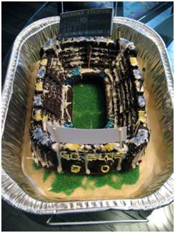 cake shaped and decorated like the University of Michigan football stadium